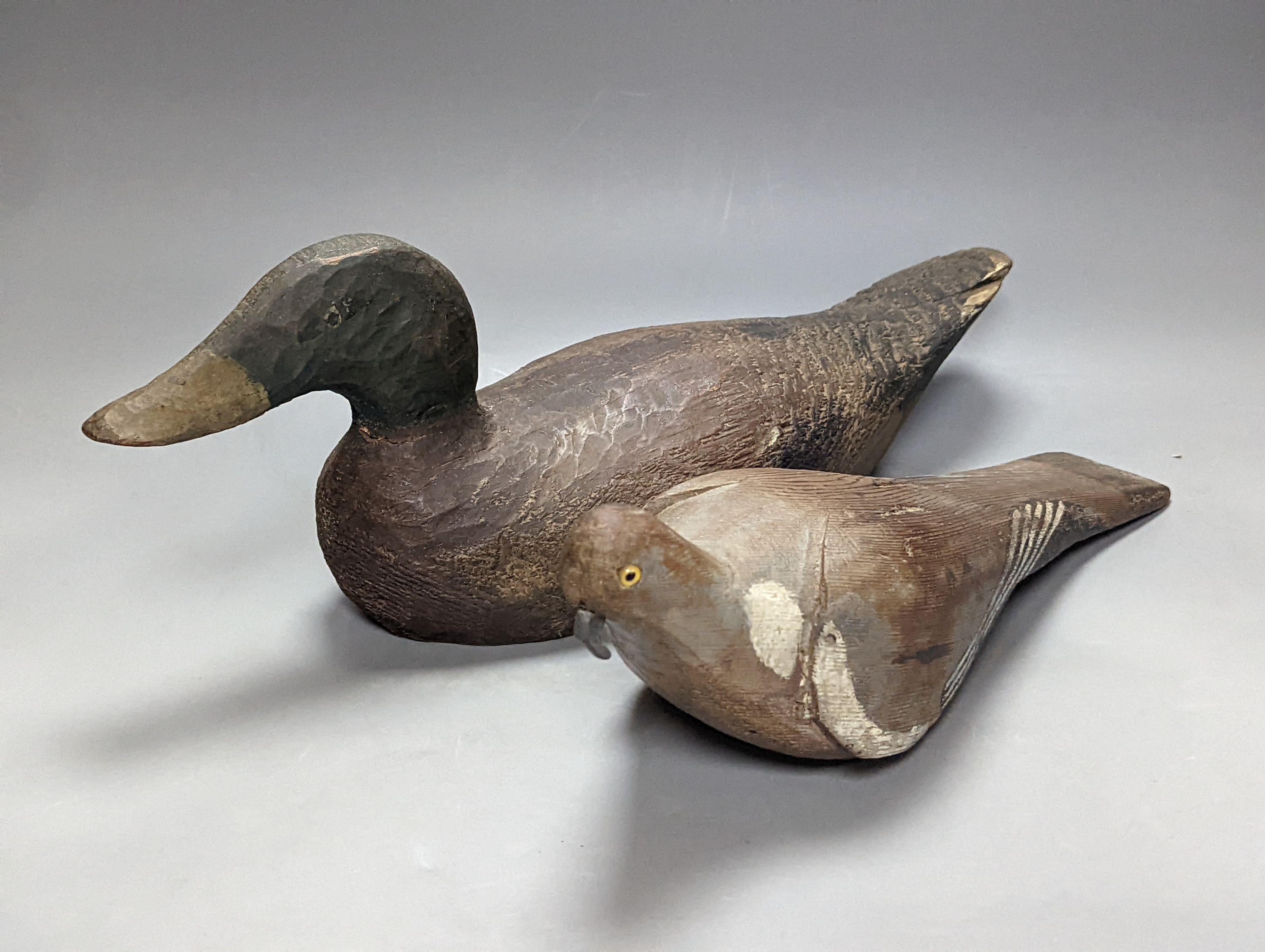 Three early 20th century decoy pigeons, largest 38cm a decoy duck, 43.5cm and a similar woodcock (5)